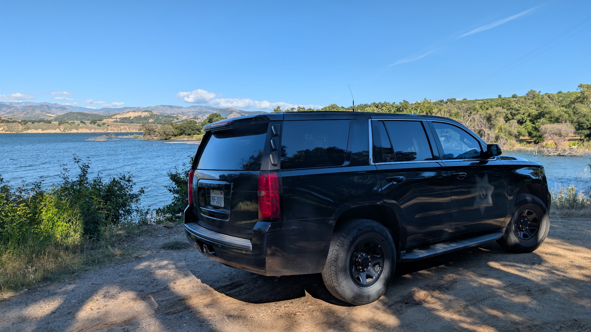 Black California Patrol Operations transport SUV near a California lake