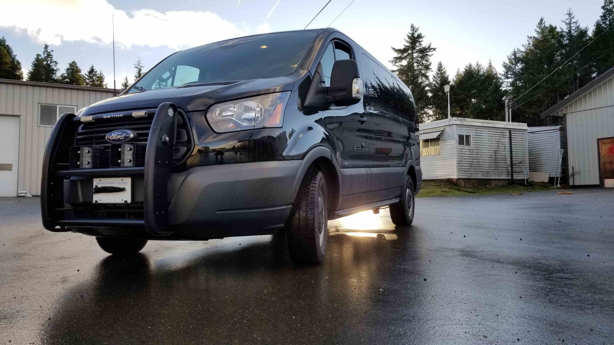 Black Ford Transit prisoner transport van with protective front equipment
